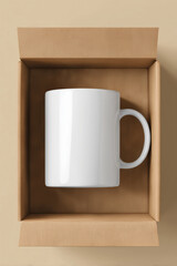Blank white ceramic mug in brown cardboard box on beige background, minimalistic design, modern homeware, coffee mug, tea cup, stylish, contemporary