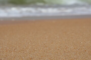 Ocean Shoreline with Receding Wave .Textured background not in focus