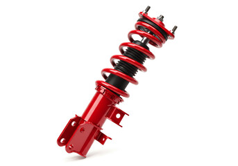 A red car suspension strut with spring and shock absorber on a white background in studio lighting