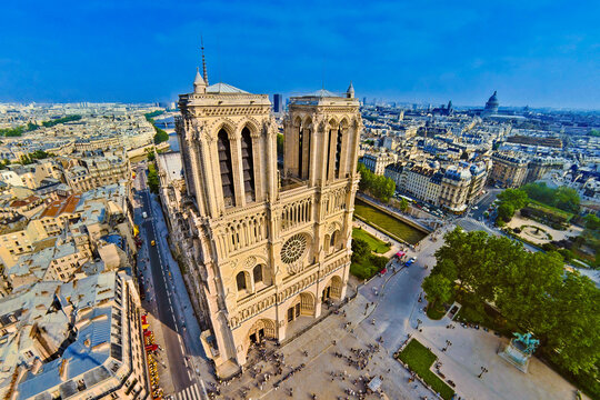 Fototapeta Aerial view of Notre Dame Cathedral standing tall amidst the urban tapestry, its intricate facade catching the sunlight, Paris, France.