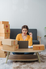 Woman shopping online with mobile phone/laptop at home