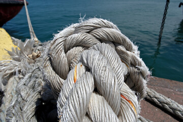 Rope on the background of the sea, closeup of photo, Rope on a mooring bollard with sea background