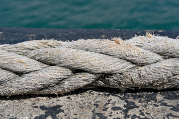 Rope on the background of the sea, closeup of photo, Rope on a mooring bollard with sea background