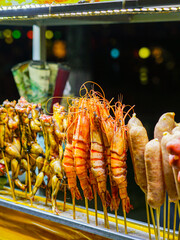 Colorful Skewers of Grilled Prawns, Frogs, and Sausages at a Vietnamese Street Food Night Market