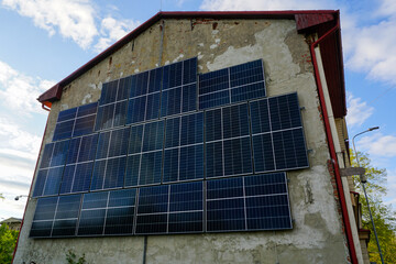 Wall-Mounted Solar Panels on an Old Building Harnessing Renewable Energy from the Morning Sun