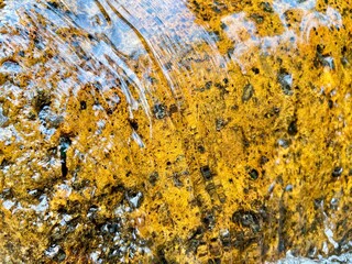 Golden Rock Under Flowing Clear Water – Nature Texture Background