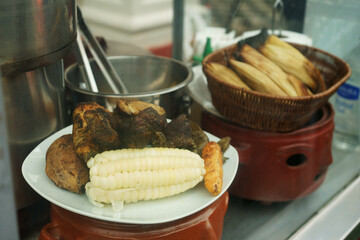 Pachamanca dish, a traditional Peruvian dish prepared with corn, meat, and potatoes. The dish is on...