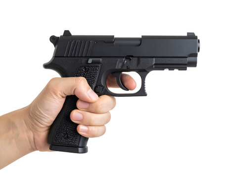 A human hand firmly grips a dark firearm, finger positioned on the trigger with intent. - Powered by Adobe