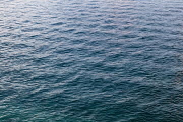 panoramic aerial view of sea water surface with calm waves and symmetrical pattern in sofft evening colors. minimalist sea surface