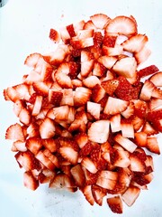 Chopped fresh strawberries on a white background 