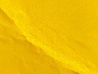 Crumpled yellow paper surface texture. Blank crumpled yellow paper in vintage style as background....