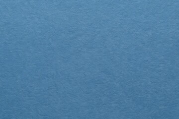 Obraz premium A close-up of a textured blue fabric with a subtle pattern, showcasing the intricate weave and color variation