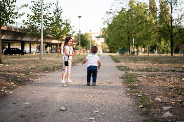 Obraz premium Two happy children playing in the park on a sunny day