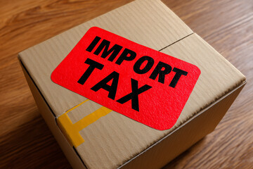 Import Tax on Brown Cardboard Box with Red Label for Global Trade and Finance