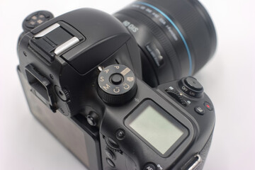Detailed view of a professional camera featuring settings dial and lens highlighting photography equipment