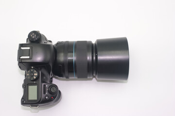 Digital camera with large lens displayed on a white background showcasing photography equipment details