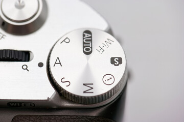 Camera settings dial showcasing various modes including auto, manual, and wireless settings for photography enthusiasts in a studio environment