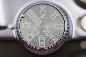 Settings dial on a camera showing various modes during a photography session