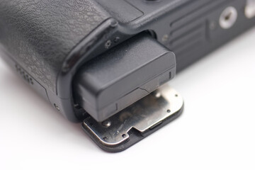 Close up view of a camera battery compartment showing detailed components and structure