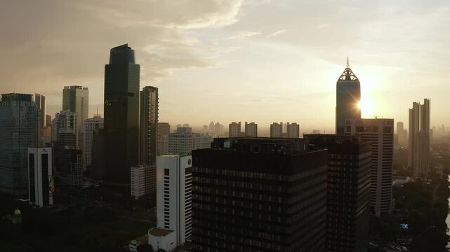 Sunset Cityscape of Jakarta with Iconic Skyscrapers and Warm Urban Glow