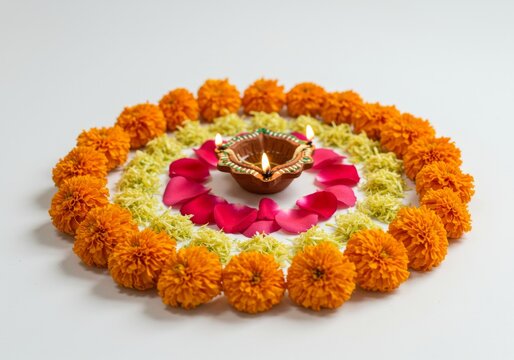 Festive Flower Rangoli with Diya - A vibrant circular rangoli design featuring marigold and zendu flowers, rose petals, and a lit diya, symbolizing prosperity, light, celebration, tradition, and