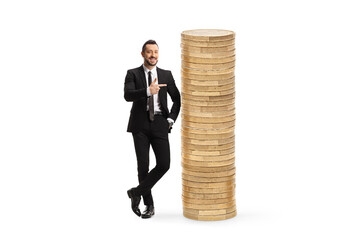 Full length portrait of a male economsit pointing at a pile of coins