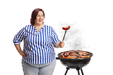 Corpulent woman grilling sausage on a bbq