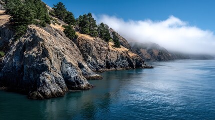 Fototapeta premium Misty coastal cliffs meet a tranquil sea.