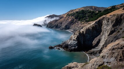 Obraz premium Coastal cliffs and sea shrouded in morning mist.