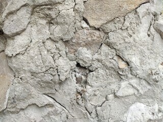 Crumbly thick plaster with rocky texture for realism in aging construction and material surfaces