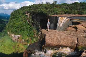 Man standing next to Kaieteur Falls in Guyana 
