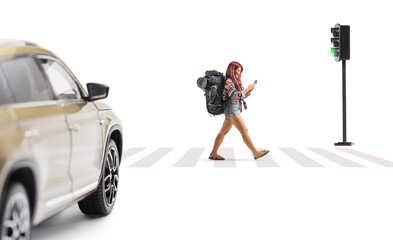 Female backpacker using a smartphone and crossing a street
