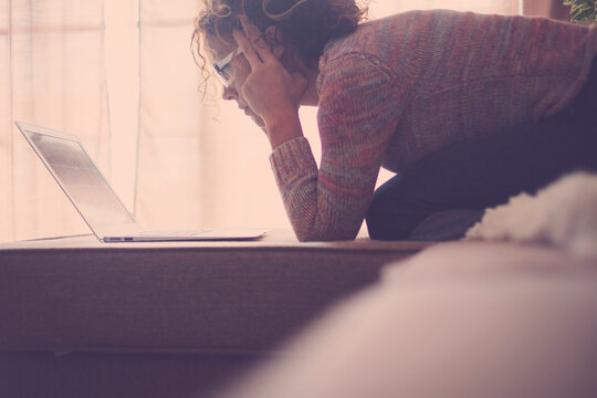 Curly-haired woman in her 40s using a laptop at home with varied expressions. Remote work, digital life, emotions and everyday routines of a modern woman navigating technology and real-world challenge