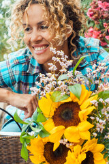 Smiling curly-haired woman in her 40s riding a city bicycle outdoors. Healthy lifestyle,...