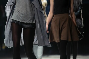 Group of women in casual clothes walking on a street.