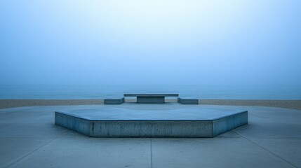 Misty, empty concrete skate park platform by the beach