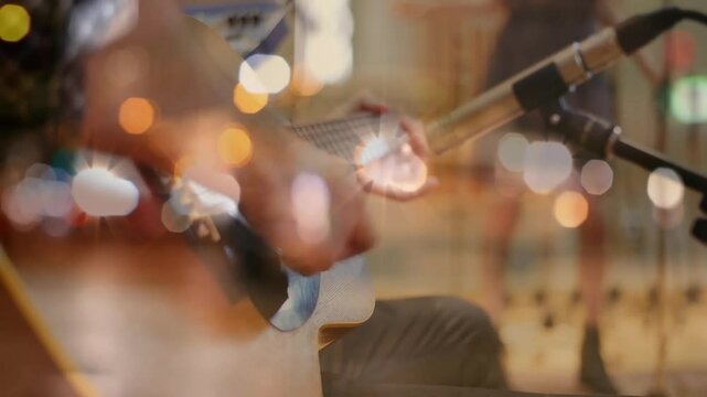 Musician placing guitar and plucking arpeggio pattern while microphone capturing performance