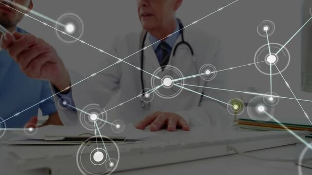 Doctor tapping file with data overlay forming and staff pointing tablet reviewing patient data
