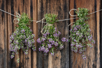 Bunches of thyme on wooden background