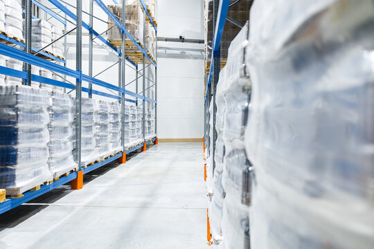 Industrial beer factory warehouse with bottled inventory in storage racks