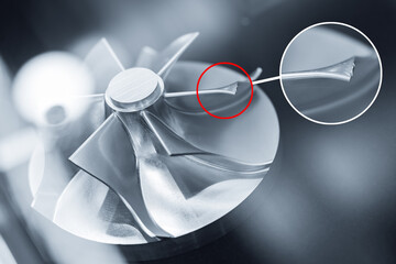 Damage during operation engineering, close-up of detailed metal turbine part component with defect
