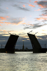 Cityscape with pink clouds at dawn. Divorced Palace Bridge over Neva. St. Petersburg
