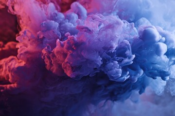 Fototapeta premium Colorful mist swirls created by mixing smoke and paint in water, showcasing vibrant hues of blue, purple, and pink in an artistic display of texture and fluid movement