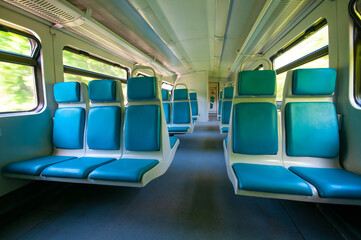 Interior of railway wagon with row comfortable blue seats