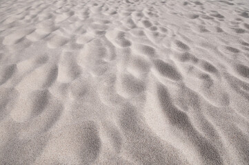 Clean gray sand on a beach as background