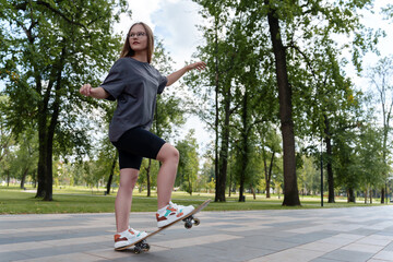 Teenage girl athlete showing off her skateboarding skills with goggles and taking risks in nature....