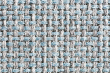 Close-up of woven fabric texture. Blue and grey intertwined threads forming a regular textile...