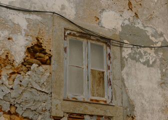abandoned building with broken window and exposed wall