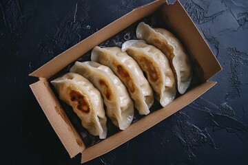 Top View of Fried Dumplings in Open Cardboard Box Takeout Asian Street Food