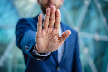 Stop hand gesture business concept professional businessman showing hand palm in front of camera